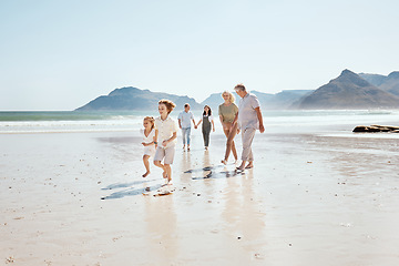 Image showing Family holding hands on beach, generations and travel with grandparents, parents and kids outdoor. Happiness, adventure and sea with love and care, people on vacation with trust and support in nature