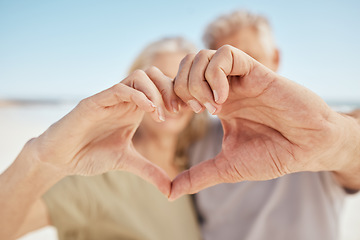 Image showing Heart, hands and closeup, love and support with health, couple outdoor in nature with travel and commitment. Trust, people at the beach with emoji, care and wellness sign, together with kindness