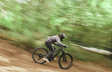 Image showing Bicycle, woods and man travel, blur and workout outdoor in forest for healthy body. Mountain bike, nature and athlete training, cycling fast and off road adventure on journey, freedom or sport race