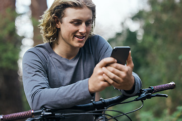 Image showing Phone, bicycle and man in forest, smile and social media, internet or sport training. Smartphone, bike and happy person in woods, cycling for healthy body on app and eco friendly transport to travel