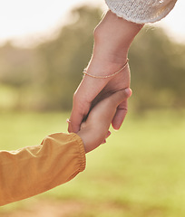 Image showing Mother, child and holding hands for walking in park for support, trust and care together or bonding in nature. Love, comfort and parent help kid in the morning sunshine with kindness on weekend