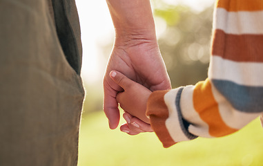 Image showing Parent, child and holding hands for walking in park for support, trust and care together or bonding in nature. Love, comfort and mother help kid in the morning sunshine with kindness on weekend