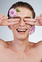 Image showing Beauty, funny and flowers on face of man in studio for spring, natural cosmetics and creative. Glow, self love and floral with model on white background for makeup, spa treatment and wellness