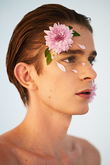Image showing Beauty, petals and flowers on face of man in studio for spring, natural cosmetics and creative. Glow, self love and floral with model on white background for makeup, spa treatment and wellness