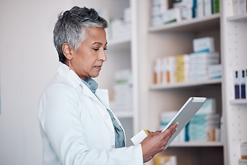 Image showing Woman, pharmacist and tablet technology, medicine shelf or healthcare inventory of boxes or stock management. Medical, pharmacy or mature doctor reading pills, product package or drugs in e commerce