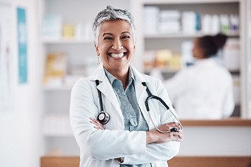 Image showing Mature, pharmacist or portrait of happy woman with arms crossed in healthcare clinic or drugstore. Proud, wellness or confident female doctor by pharmacy medication or medicine on shelf ready to help