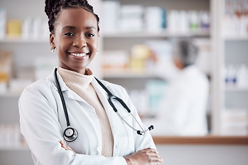 Image showing Black woman, doctor in portrait with arms crossed and healthcare, medical professional and hospital dispensary. Pharmacy, health and confidence, smile with wellness and drugs, medicine and service