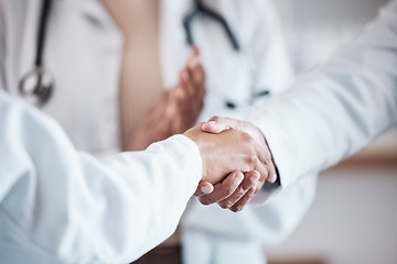 Image showing Closeup, teamwork or doctors shaking hands for goal, good job or promotion success in a hospital meeting. Clapping, congratulations or proud healthcare worker with handshake for medical collaboration