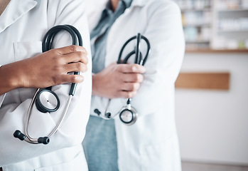 Image showing People, doctor and hands of professional with stethoscope in healthcare, pharmaceutical or help at pharmacy. Closeup of medical experts with arms crossed in confidence for health service at drugstore