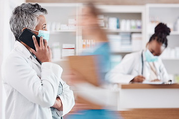 Image showing Woman, pharmacist and phone call with face mask in Telehealth, consultation or conversation at pharmacy. Female person or medical healthcare professional talking on mobile smartphone in online advice