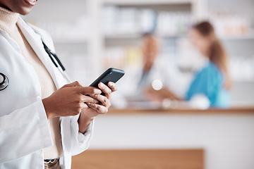 Image showing Woman pharmacist with phone, typing in clinic and research for medical information, email or online chat. Smartphone, networking and mockup, doctor in pharmacy checking social media or internet news
