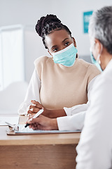 Image showing Face mask, doctor or nurse consulting a patient in meeting in hospital writing history or healthcare record. People, medical or nurse with black woman talking or speaking of test results or advice