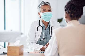 Image showing Face mask, mature or doctor consulting a patient in meeting in hospital writing history or healthcare record. People, medical or happy nurse with woman talking or speaking of test results or advice