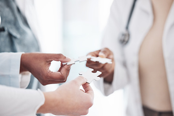 Image showing Doctor, team and hands with puzzle piece connection for solidarity, medical community and teamwork. Hospital, clinic and healthcare group with engagement, support and development of surgeon staff