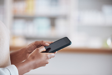 Image showing Woman pharmacist with smartphone, typing in clinic and research for medical information, email or online chat. Phone, networking and mockup, doctor in pharmacy checking social media or internet news