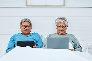 Image showing technology, online or old couple in bed on social media on the internet together at home to relax. Morning, senior man or mature woman browsing or networking on a digital tablet and laptop in bedroom