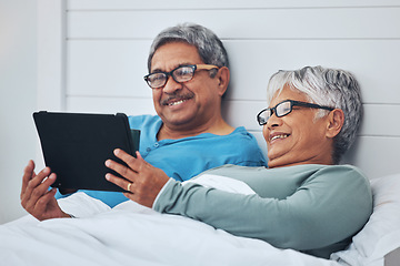 Image showing Tablet, mature couple and happy in bedroom at home together on social media, streaming movie or film in the morning. Technology, man smile and woman in bed, bonding or reading online news to relax
