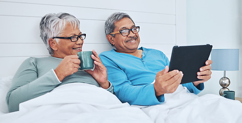 Image showing Tablet, mature couple and coffee in bed at home together on social media, streaming movie and film in the morning. Tech, man and woman drink tea in bedroom, bonding and smile reading news to relax