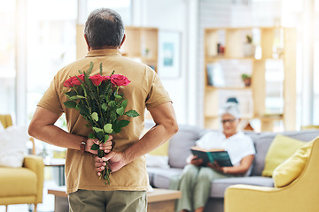 Image showing Love, surprise and senior man with roses behind back for romance, gratitude and commitment to wife in living room of home. Couple, person and flowers in hand for gift and marriage anniversary