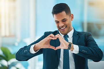 Image showing Hands, heart and happy business man with love, care and kindness of like emoji in office. Corporate employee, smile and finger shape for thank you, trust and sign of hope, support and icon of peace