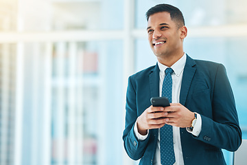 Image showing Phone, thinking and mockup with a business man in his office, typing a text message for communication. Mobile, idea and networking with a happy young employee chatting online in a corporate workplace