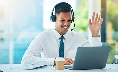 Image showing Call center, laptop and man wave in video in customer service, support or help desk office. Happy, hello and sales agent in webinar communication, consulting and telemarketing in online conference