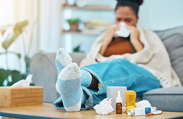 Image showing Woman, sick and pills, allergies and medicine with feet on table, healthcare and sinus infection. Virus, bacteria and sneezing, pharmaceutical drugs for illness and tissue, relax on sofa and health