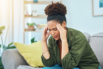 Image showing Woman, headache and pain on sofa for stress, dizzy and challenge of mental health at home. Sad african person frustrated for migraine, anxiety or depression of fatigue, debt or vertigo in living room