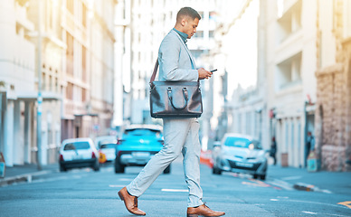Image showing Phone, city sidewalk and business man walking, typing and texting professional legal contact, lawyer or advocate. Cellphone communication, crossing road or corporate attorney on urban commute journey
