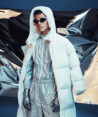 Image showing Holographic, vaporwave clothes and man with fashion and futuristic ski style with sci fi in studio. Art, creative and young male model with trendy, cool sunglasses and cyberpunk designer jacket