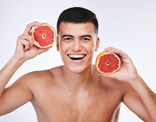 Image showing Beauty, grapefruit and natural with portrait of man in studio for health, detox or cosmetic. Vitamin c, nutrition and skincare with face of person and fruit on white background for self care and glow