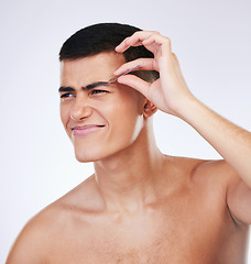 Image showing Man, tweezer and skincare with facial and beauty treatment for skin glow and wellness in studio. Male model, dermatology pain and hair removal tool for eyebrows pull and face with grey background