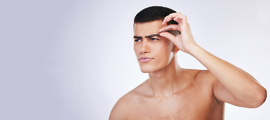 Image showing Man, grooming and clean skincare with facial and beauty treatment for skin and wellness in studio. Male model, dermatology and hair removal tool of eyebrows with grey background and mockup space