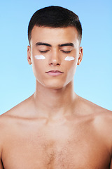 Image showing Self care, skincare or man with face cream product for beauty or natural moisturizer or cosmetics in studio. Blue background, eyes closed or model with facial creme or dermatology lotion for glow