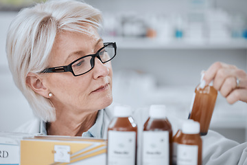 Image showing Senior woman, pharmacist and inventory inspection, medicine or checking stock on shelf at drugstore. Mature female person, medical or healthcare employee reading pharmaceutical product at pharmacy