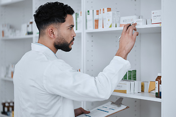 Image showing Man, pharmacist and inventory inspection on shelf in checking stock, medication or pills at pharmacy. Male person, medical or healthcare professional reading pharmaceutical product, drug or checklist