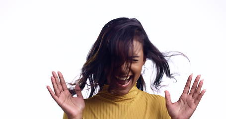 Image showing Smile, crazy and a woman with wind on a white background for beauty, hair or comedy. Happy, model and an Indian girl or person with bad weather, fun or excited while isolated on a studio backdrop