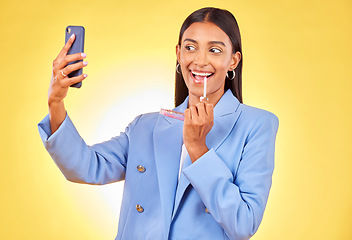 Image showing Business woman, selfie and lipstick by studio background with thinking, vision and smile with check. Entrepreneur, fashion model and makeup with lips, cosmetics and ideas for beauty with photography