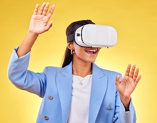 Image showing Business woman, virtual reality glasses and studio with hands, smile and 3d user experience by yellow background. Futuristic tech entrepreneur, ar vision and happy for metaverse, cyber ux or system