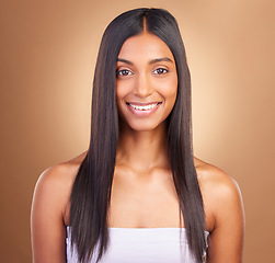 Image showing Portrait, hair care and woman with a smile, shine and skincare on a brown studio background. Face, person and model with happiness, aesthetic or glow with healthy skin, texture and volume with beauty
