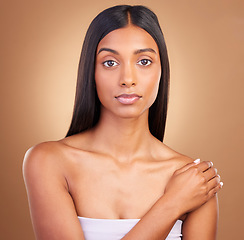 Image showing Portrait, hair care and woman with dermatology, skincare and volume on a brown studio background. Face, person and model with natural beauty, aesthetic and glow with healthy skin, texture and shine