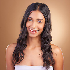 Image showing Portrait, hair care and woman with dermatology, cosmetics and skincare on a brown studio background. Face, person and model with happiness, aesthetic and glow with texture, volume and natural beauty