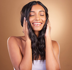 Image showing Portrait, hair care and woman with a smile, volume and wellness on a brown studio background. Face, person and model with shine, texture and aesthetic with dermatology, shampoo or cosmetics with glow