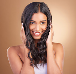 Image showing Portrait, hair care and woman with a smile, beauty and cosmetics on a brown studio background. Face, person and model with dermatology, aesthetic or glow with shine, texture and volume with wellness