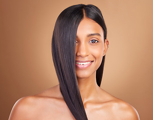 Image showing Portrait, hair care and woman with beauty, shine or dermatology on a brown studio background. Face, person or model with aesthetic, grooming or glow with healthy skin, texture or volume with wellness