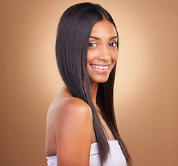 Image showing Portrait, hair care and woman with glow, shine and texture with volume on a brown studio background. Face, person or model with cosmetics, aesthetic or dermatology with healthy skin or natural beauty