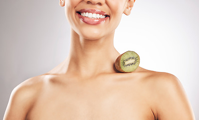 Image showing Skincare, kiwi and woman in studio smile for natural, beauty or treatment or eco friendly cosmetics on white background. Wellness, skin and female model with fruit for collagen, detox or vitamin C