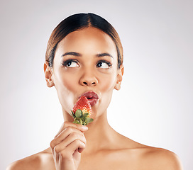 Image showing Skincare, kiss and woman with strawberry in studio for wellness, nutrition or natural cosmetics on white background. Beauty, face and female model with fruit for antioxidants or anti aging fine lines