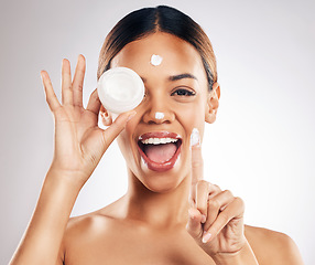 Image showing Woman, cream container and hands for eye skincare, beauty or cosmetics application on a white background. Excited person in happy portrait for collagen, moisturizer and dermatology health in studio