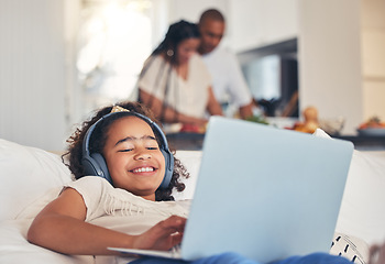 Image showing Child, laptop and headphones on sofa for happy video streaming, audio subscription and e learning at home. Kid relax on couch listening to music, games and online education on computer in living room